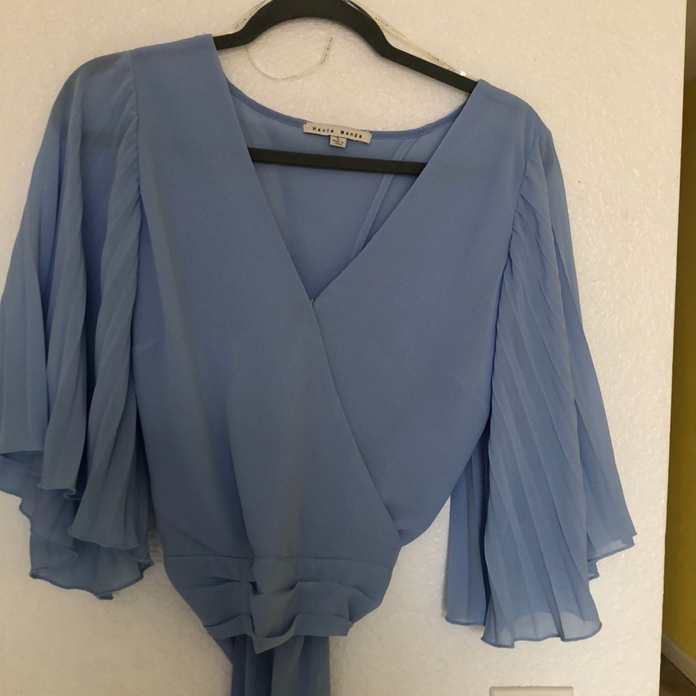 Baby blue shirt cropped . Ties in the back